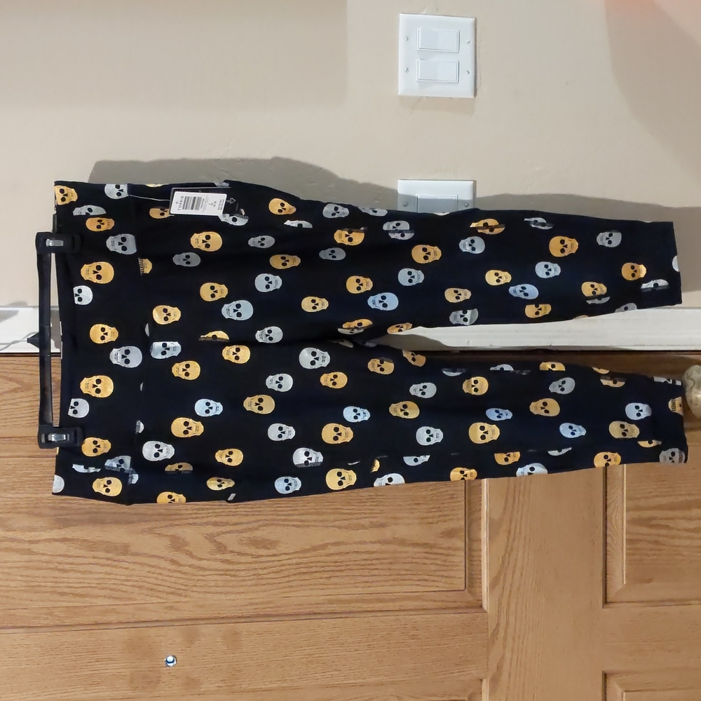 Torrid, black high-rise silver/gold glitter skull leggings with pockets